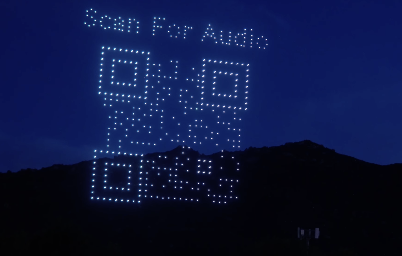 Drones forming a scannable Scan For Audio QR code in the sky during SkyRender Sync