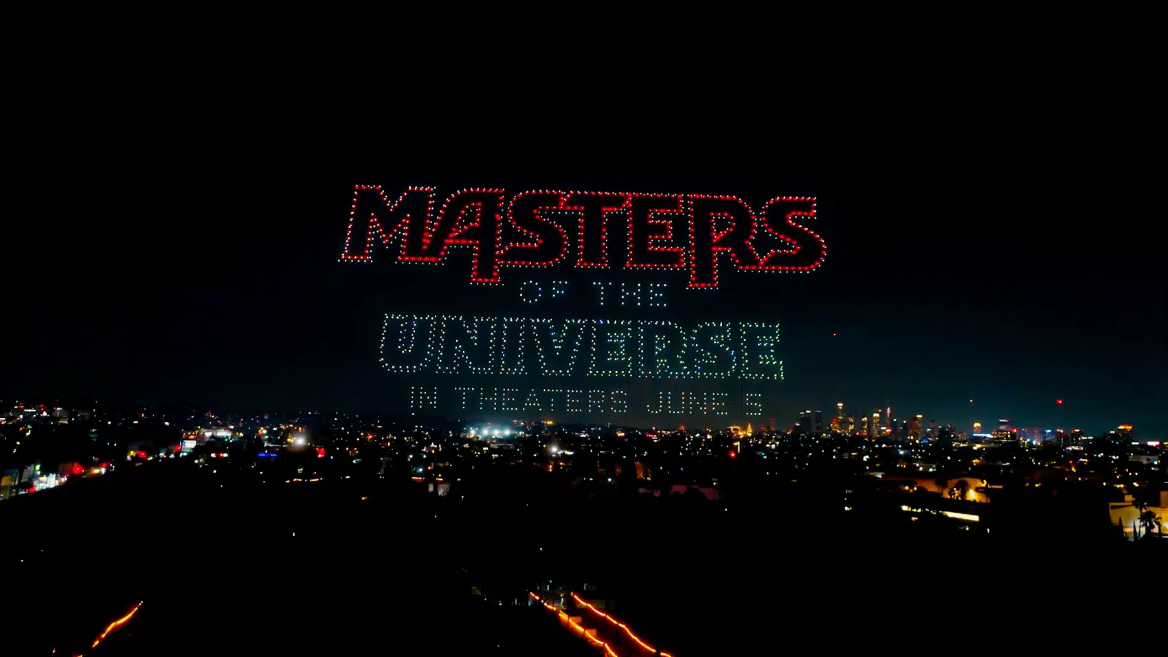 Drone formation of He-Man and the Sword of Power glowing above Los Angeles