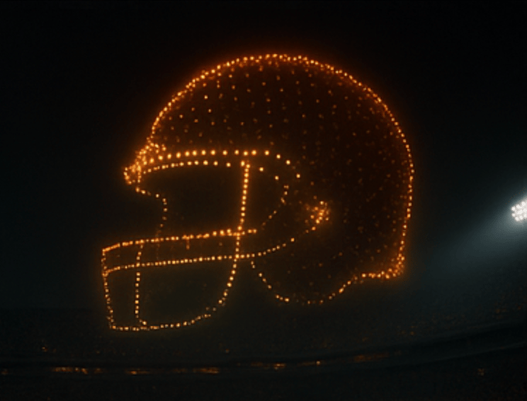 Drone formation creating an American football helmet — Creative Skies sports show