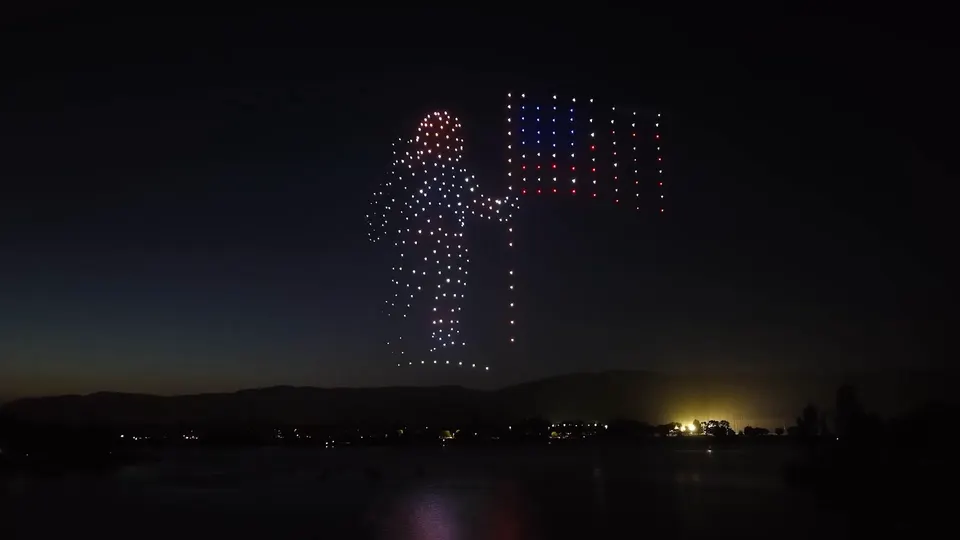A drone figure saluting the American flag